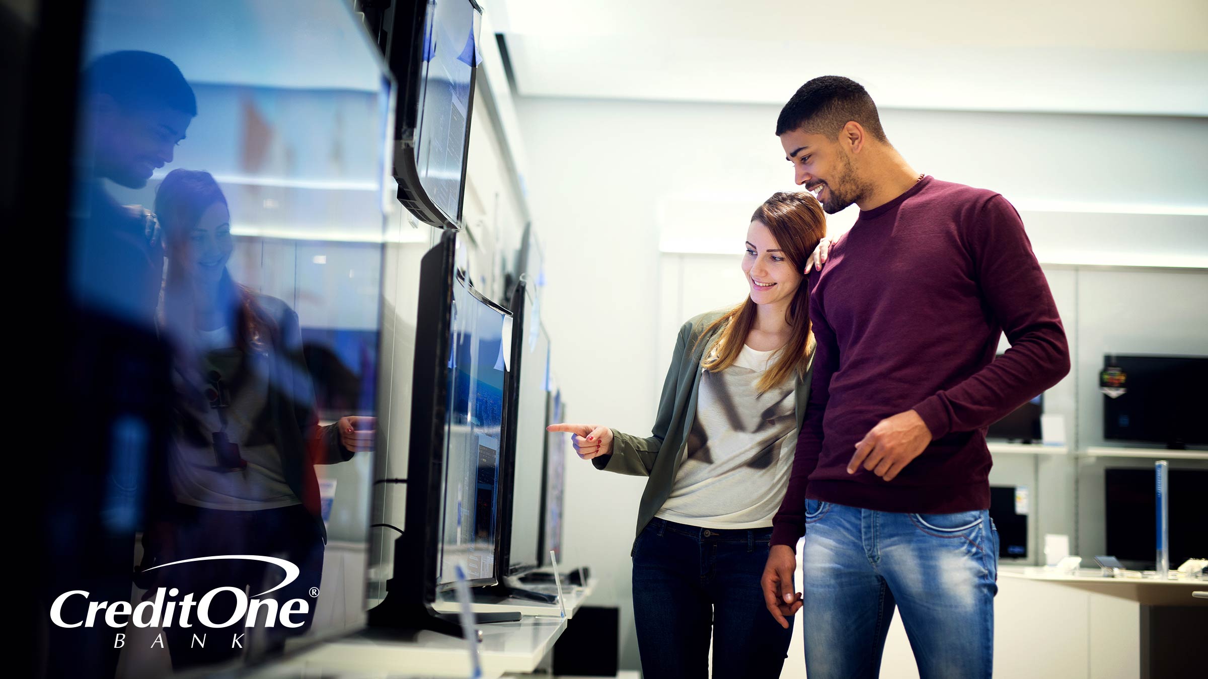 A couple browsing potential TV purchases